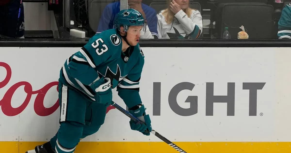 Hockey player in teal jersey skating on ice Hockey player in teal jersey skating on ice