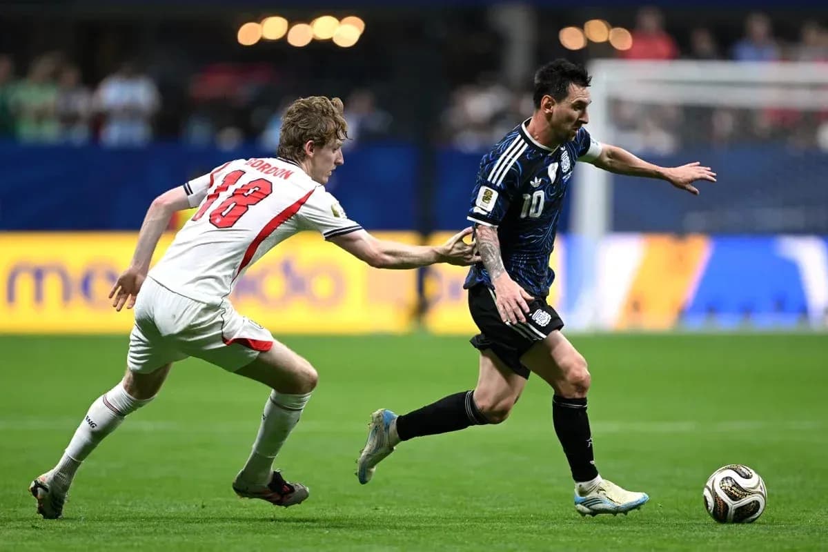 Player dribbling the ball while being challenged Player dribbling the ball while being challenged