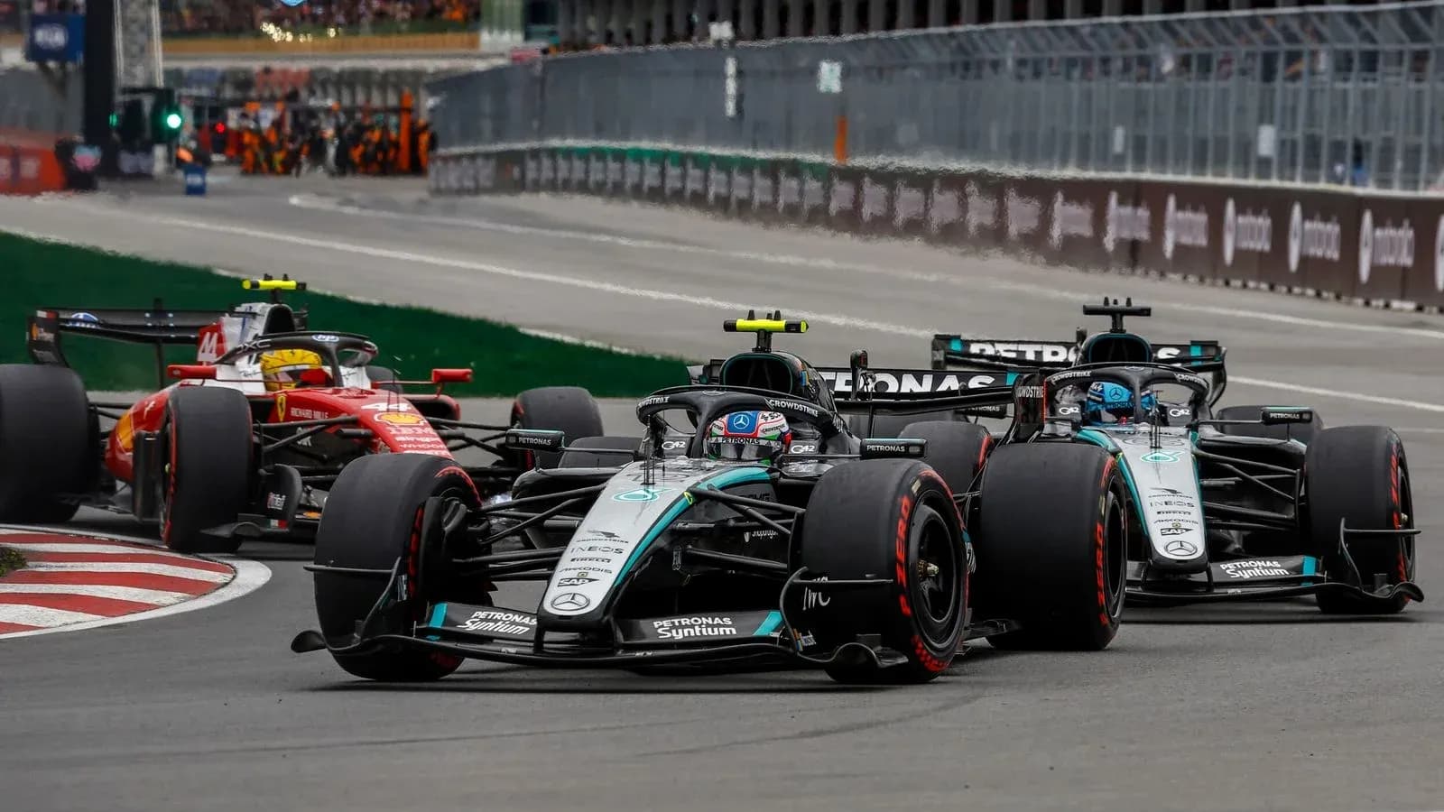 Mercedes and Ferrari cars racing on track Mercedes and Ferrari cars racing on track