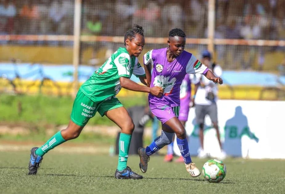 Two players competing for the ball in match Two players competing for the ball in match