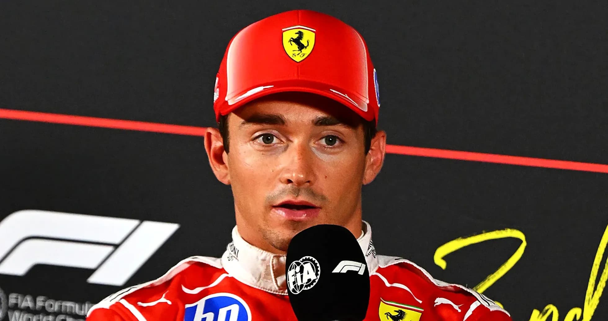 F1 driver speaking at press conference with microphone F1 driver speaking at press conference with microphone