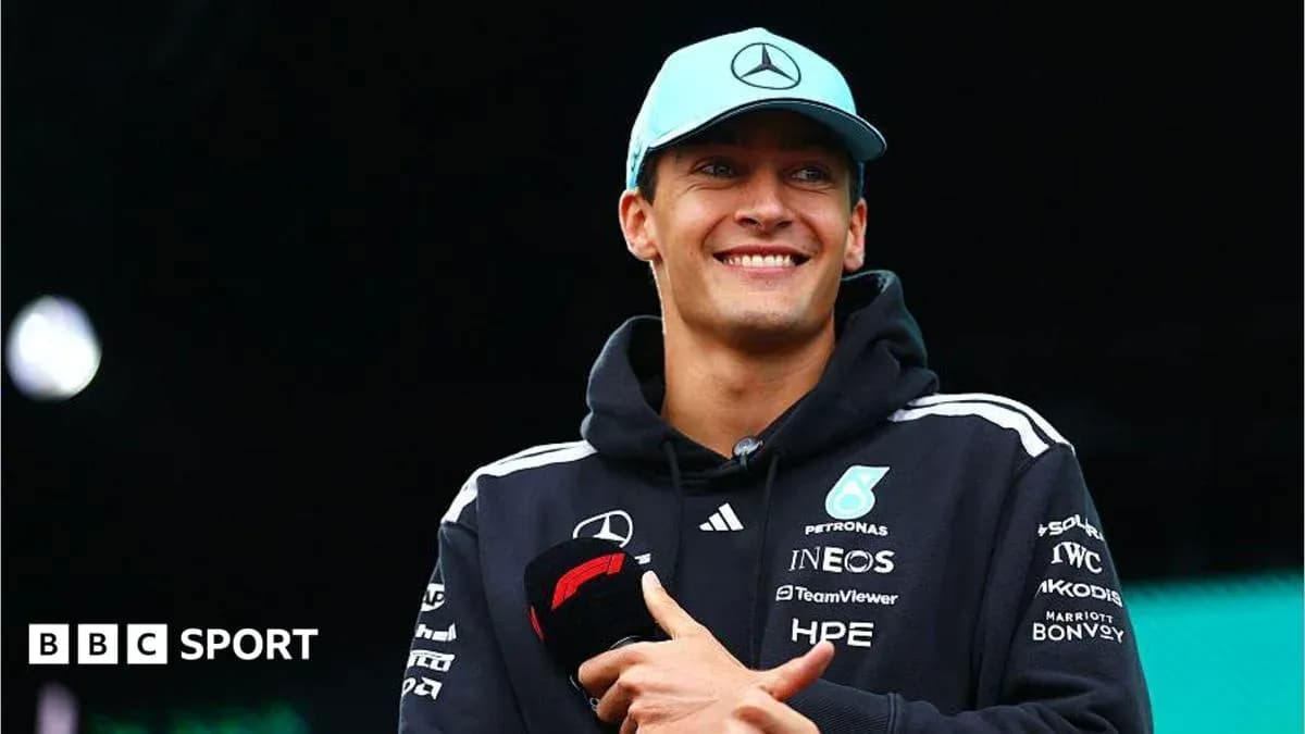 F1 driver smiling during event with microphone F1 driver smiling during event with microphone
