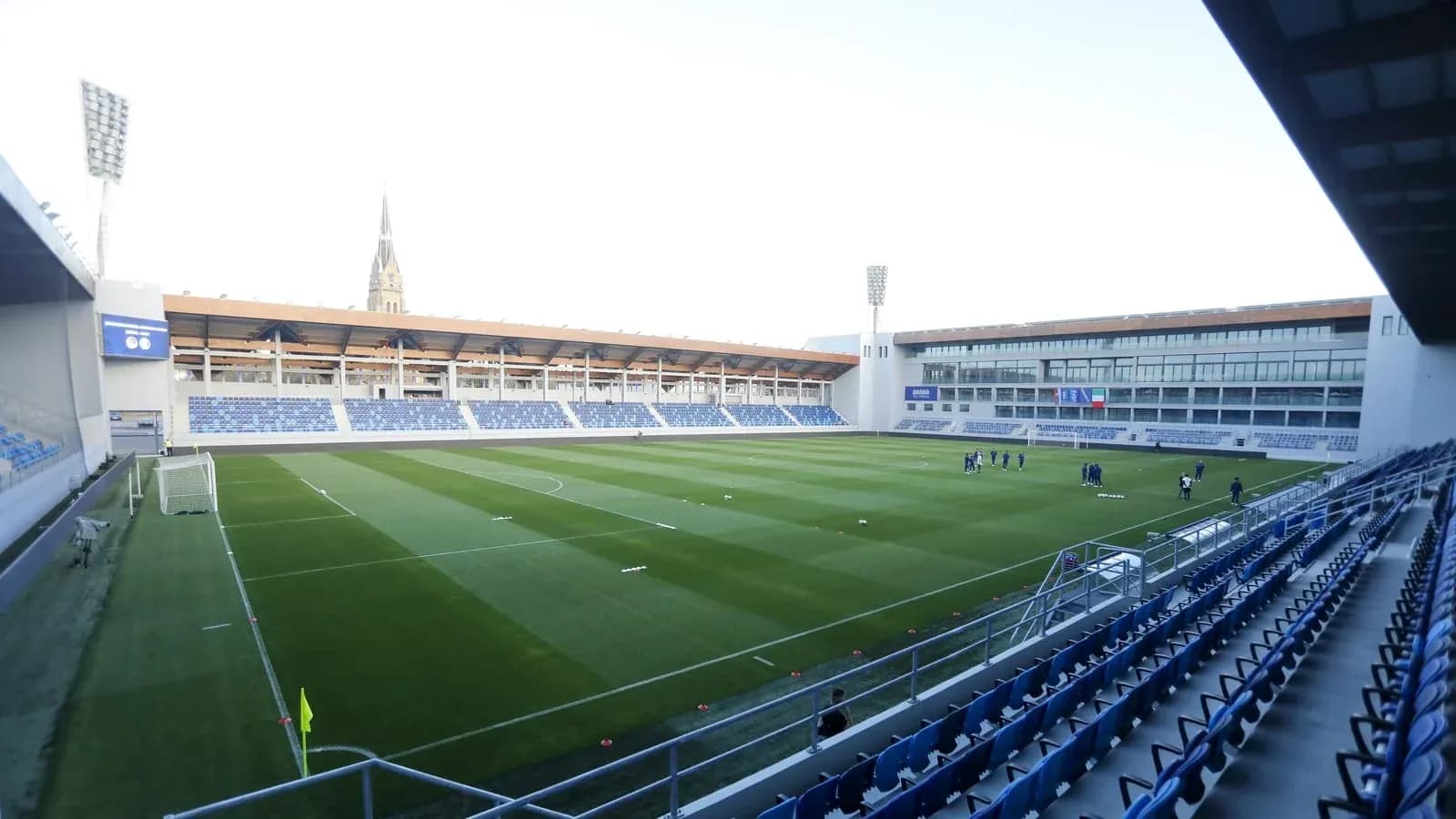 Stadium view with players training on the pitch Stadium view with players training on the pitch
