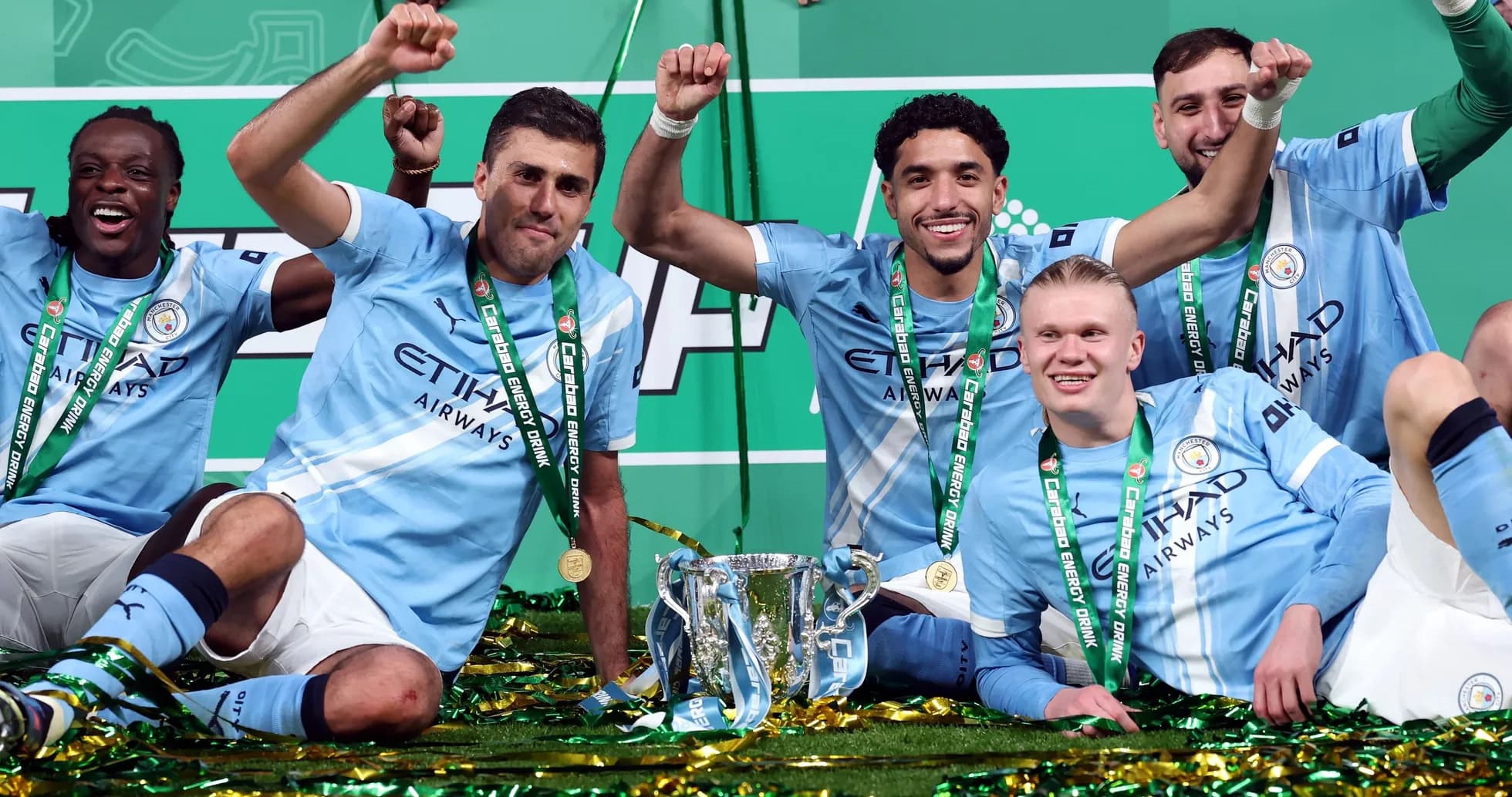 Manchester City players celebrating with trophy and medals Manchester City players celebrating with trophy and medals