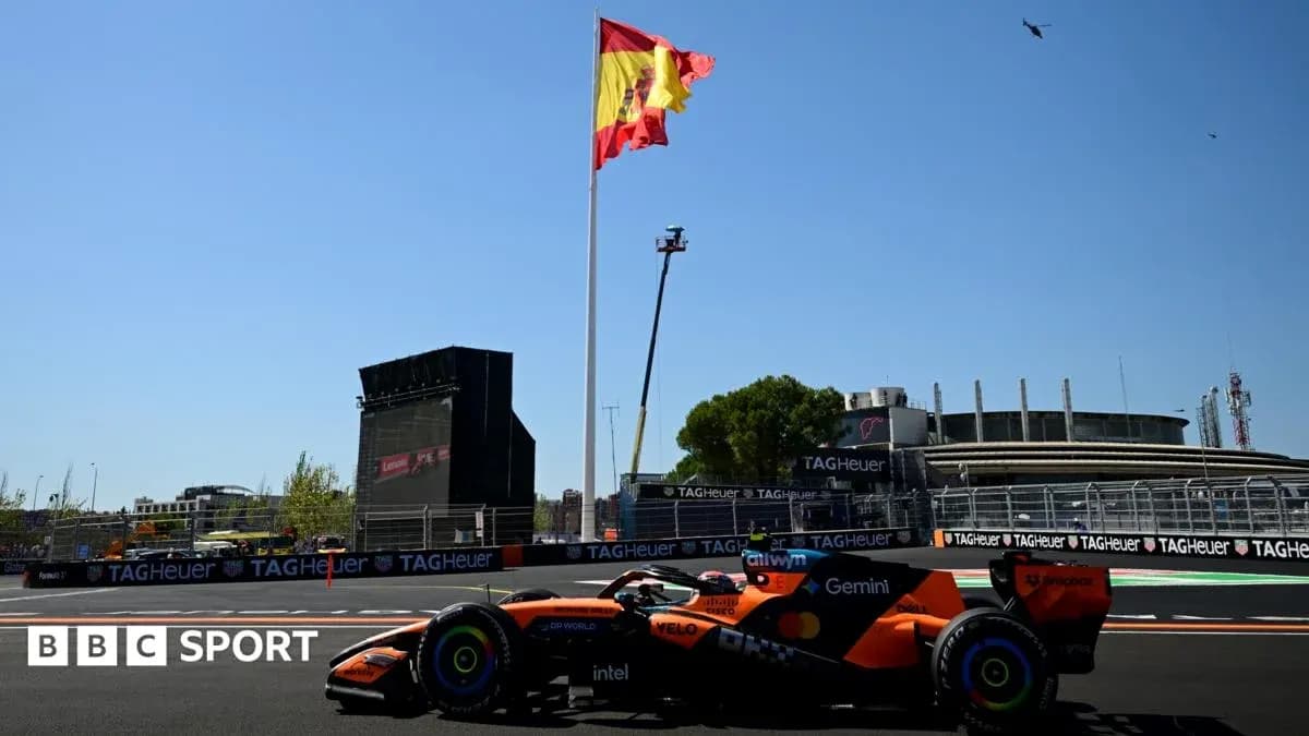Formula 1 car on track with Spanish flag backdrop Formula 1 car on track with Spanish flag backdrop