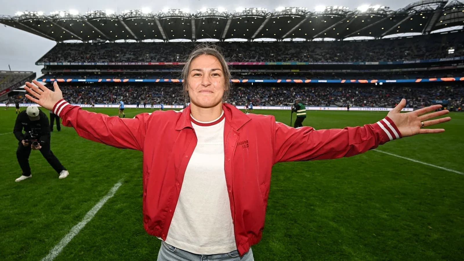 Player celebrating on the field with arms outstretched Player celebrating on the field with arms outstretched