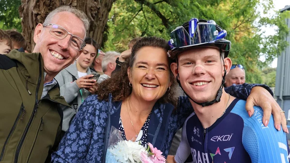 Three people celebrating with flowers after cycling event Three people celebrating with flowers after cycling event