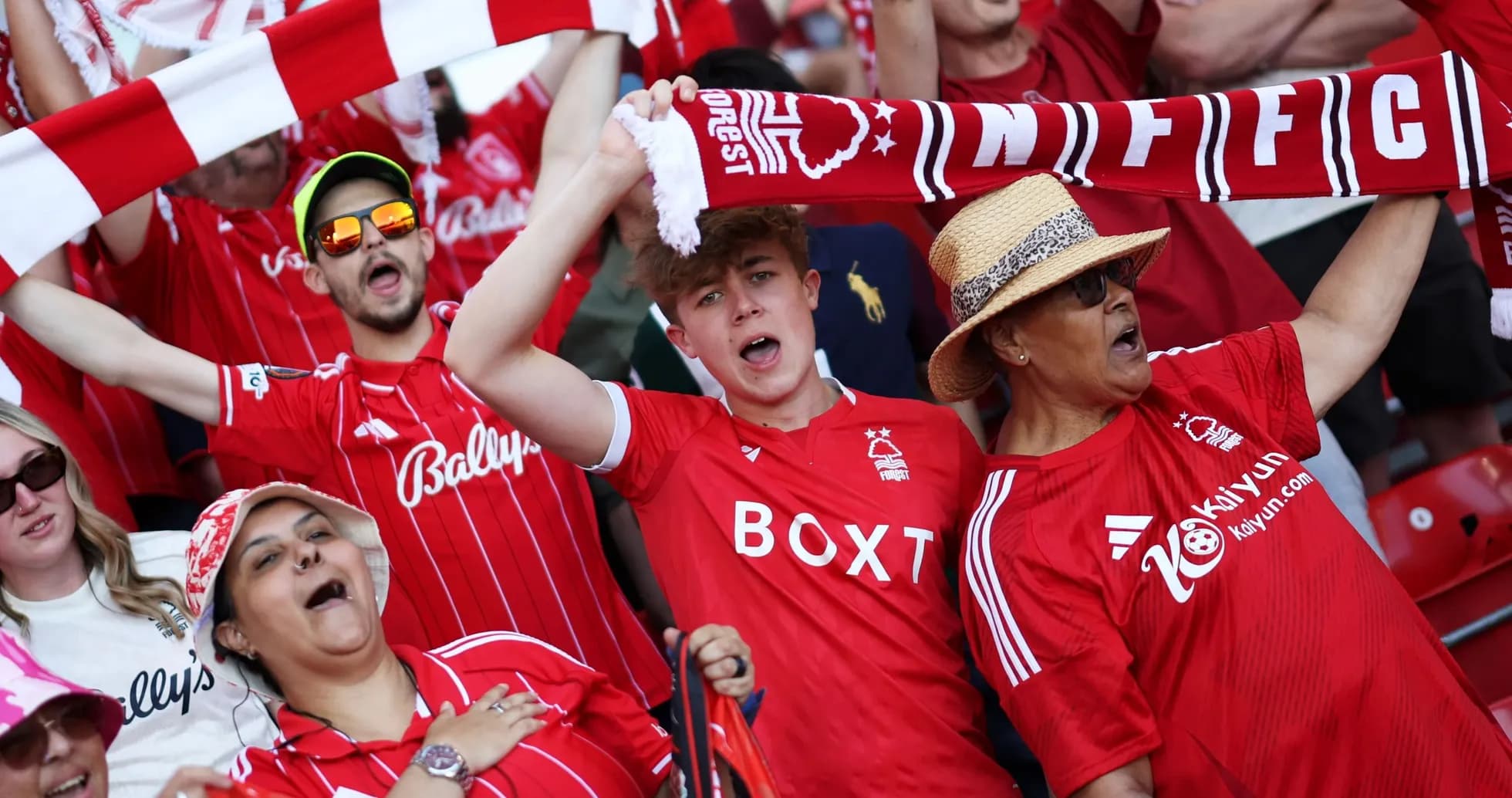 Fans cheering and waving scarves in stadium Fans cheering and waving scarves in stadium