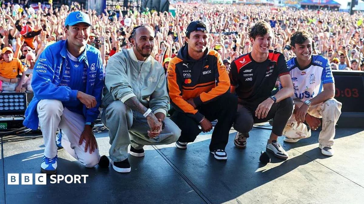 Formula 1 drivers posing on stage at event Formula 1 drivers posing on stage at event