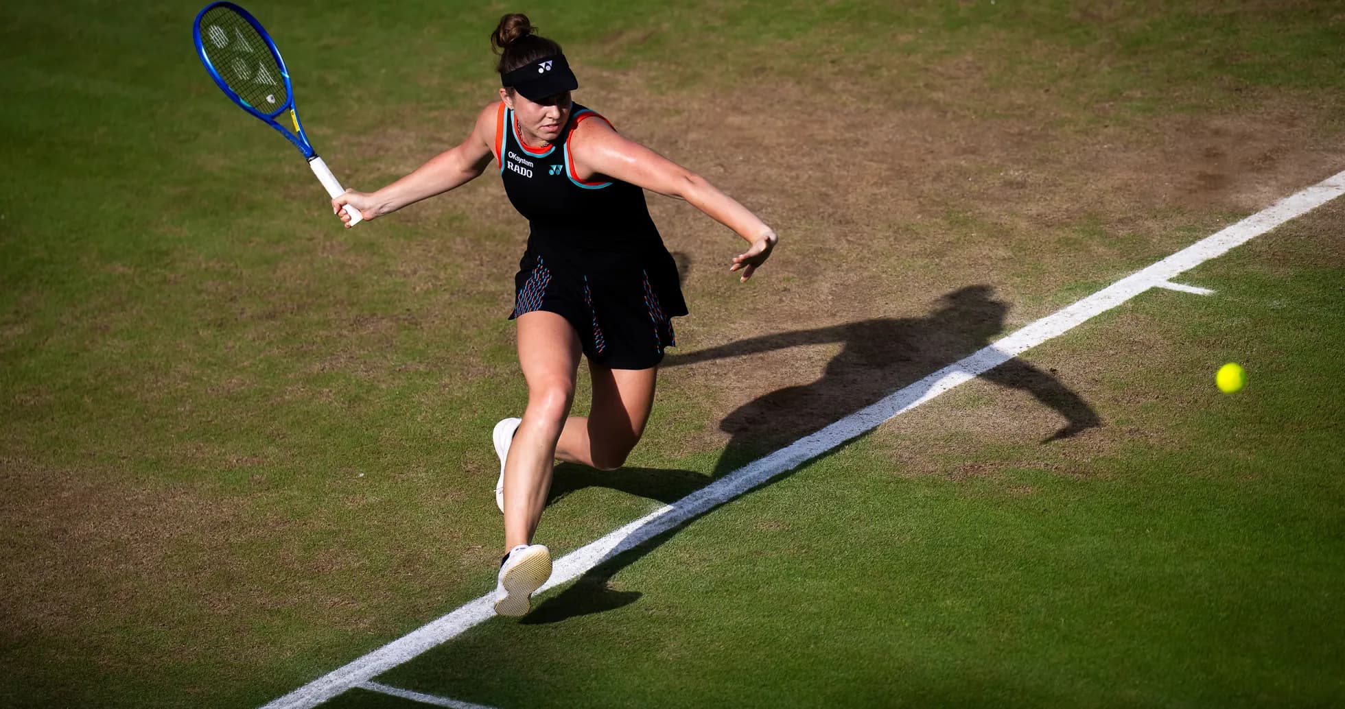 Tennis player returning a shot on grass court Tennis player returning a shot on grass court