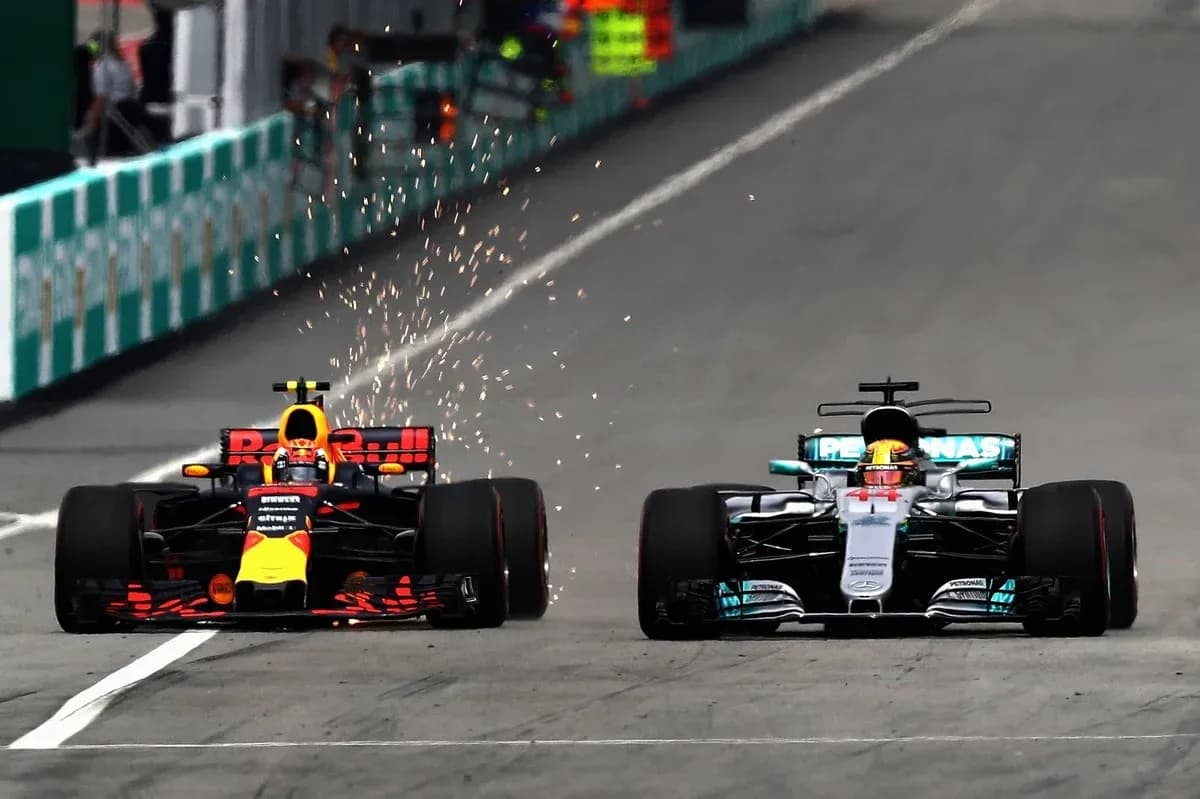 Red Bull and Mercedes cars racing with sparks flying Red Bull and Mercedes cars racing with sparks flying