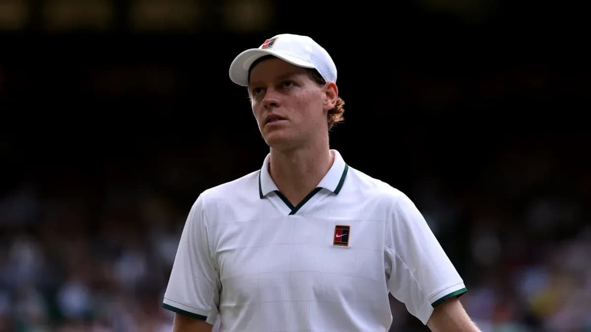 Tennis player in white shirt walking on court Tennis player in white shirt walking on court