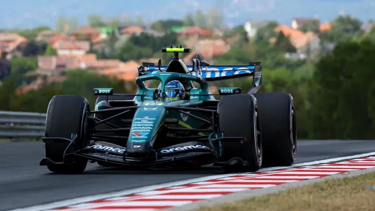 Formula 1 car racing on track with trees in background Formula 1 car racing on track with trees in background