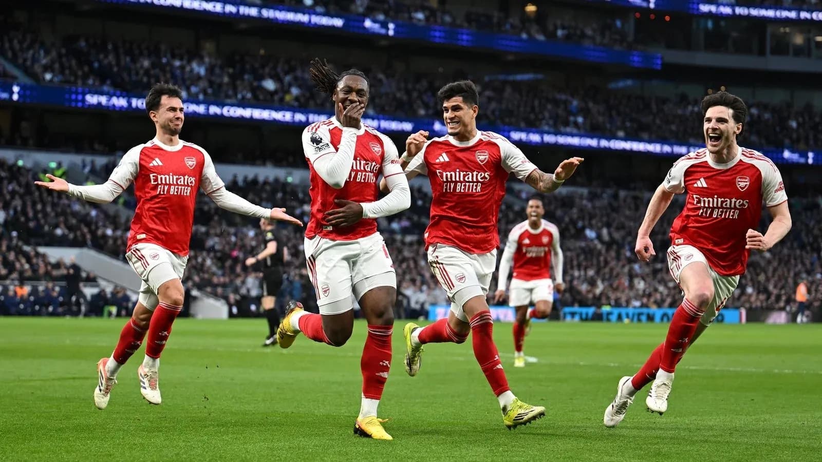 Arsenal players celebrating a goal on the field Arsenal players celebrating a goal on the field