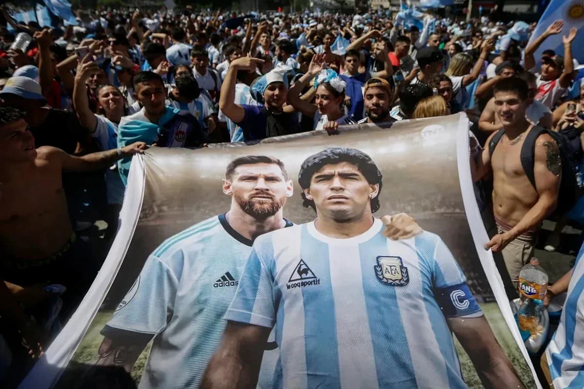 Fans holding banner of Messi and Maradona in crowd Fans holding banner of Messi and Maradona in crowd