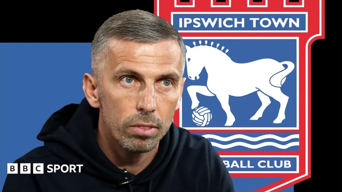 Manager speaking in front of Ipswich Town logo Manager speaking in front of Ipswich Town logo