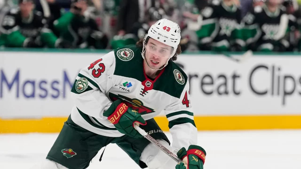 Hockey player skating on ice during game Hockey player skating on ice during game