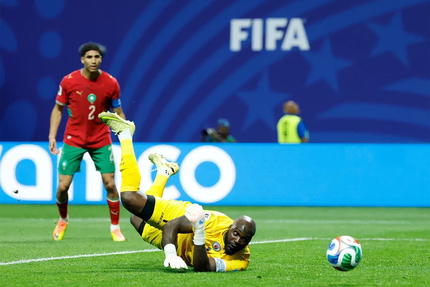Goalkeeper diving for the ball during match action Goalkeeper diving for the ball during match action
