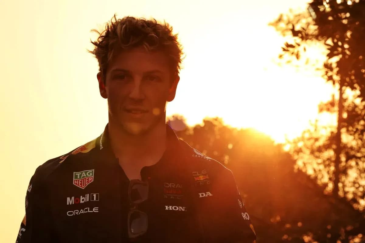 Yoshida sunsetting behind a racing driver in uniform Yoshida sunsetting behind a racing driver in uniform