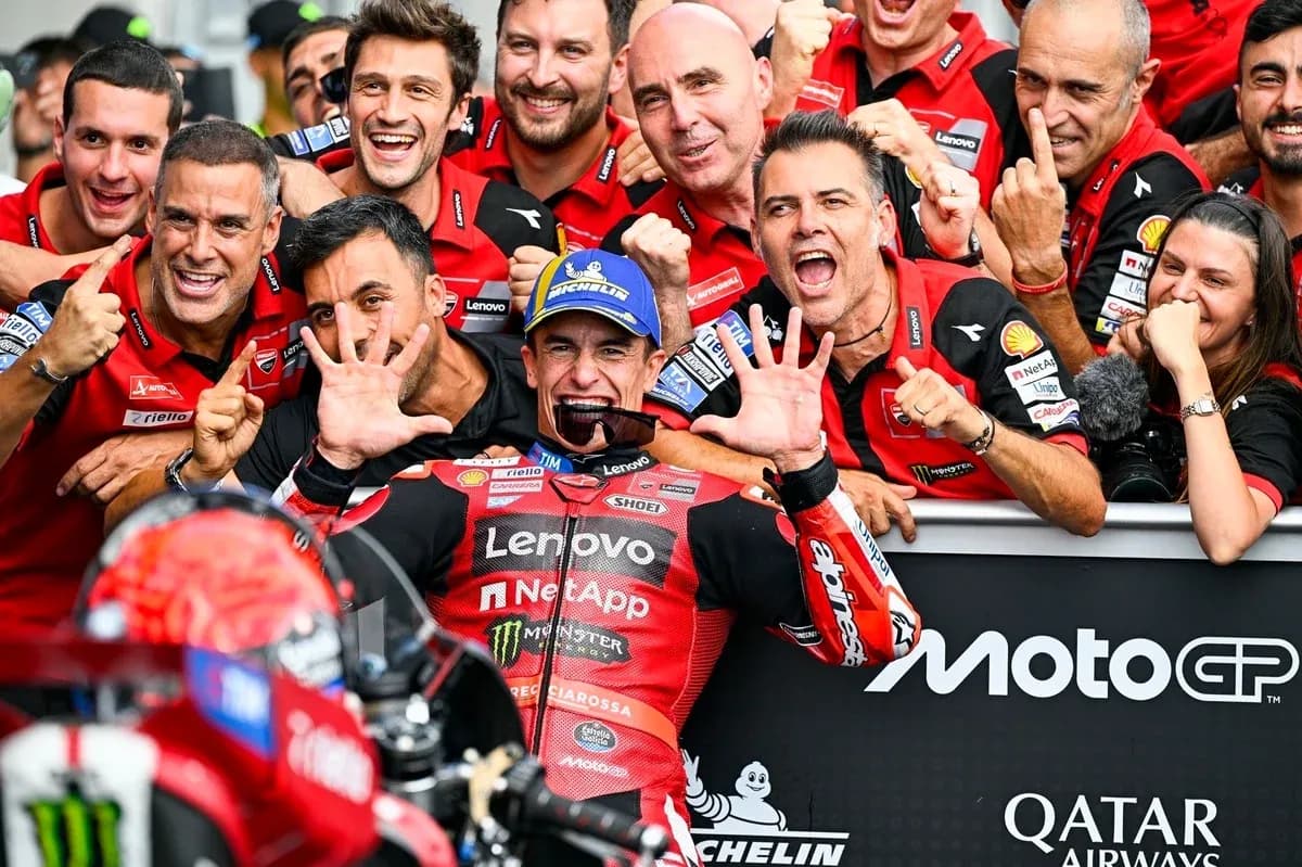 Ducati team celebrating victory with rider at event Ducati team celebrating victory with rider at event