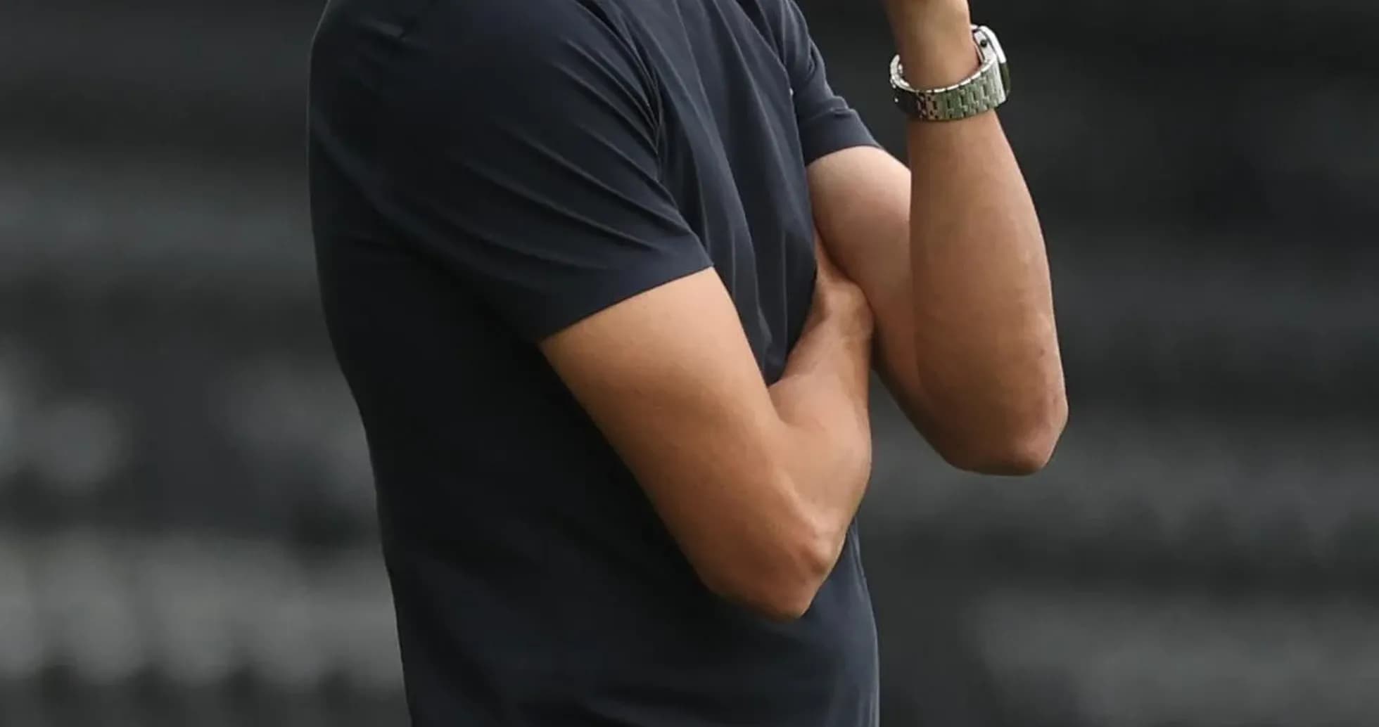 Coach observing match with arms crossed Coach observing match with arms crossed