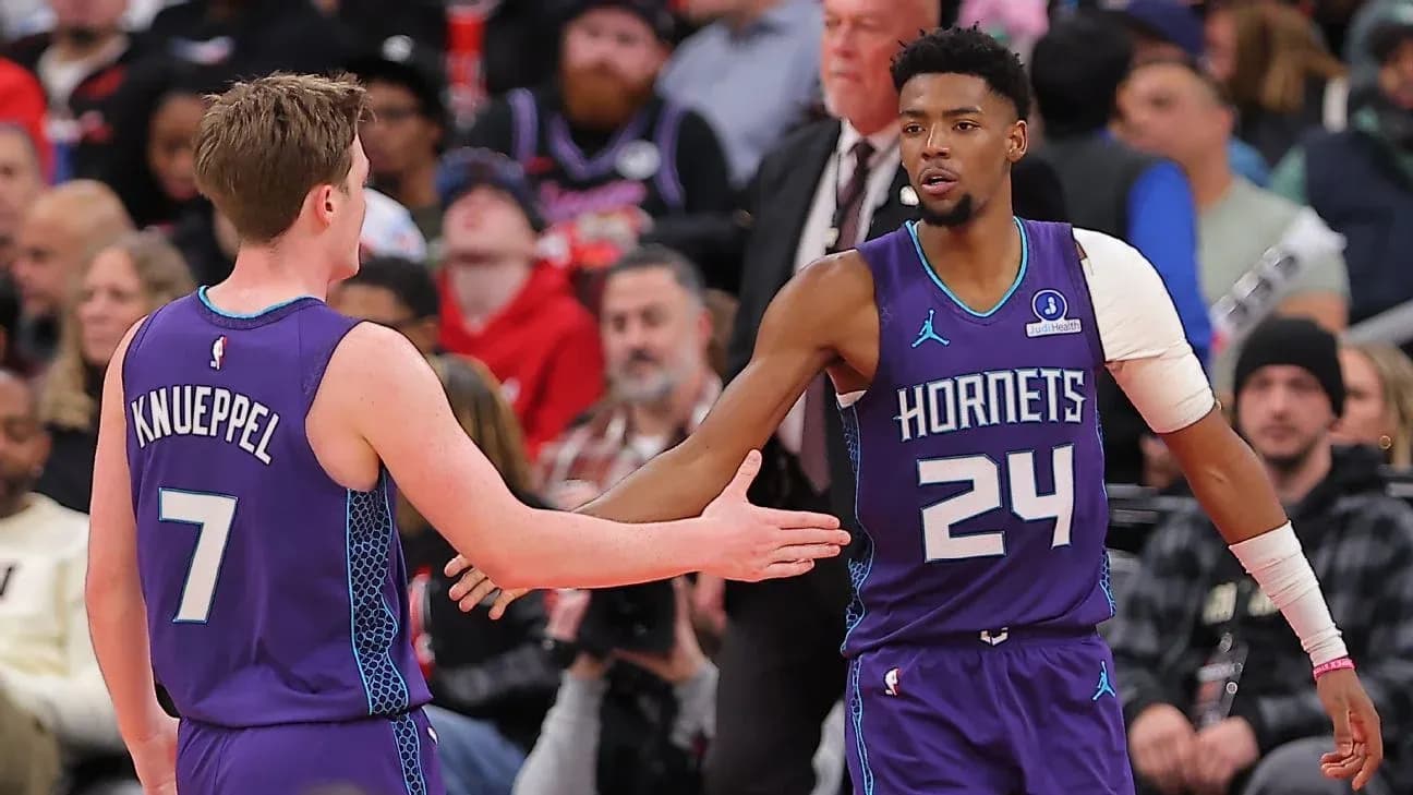 Two Hornets players celebrating during a game Two Hornets players celebrating during a game