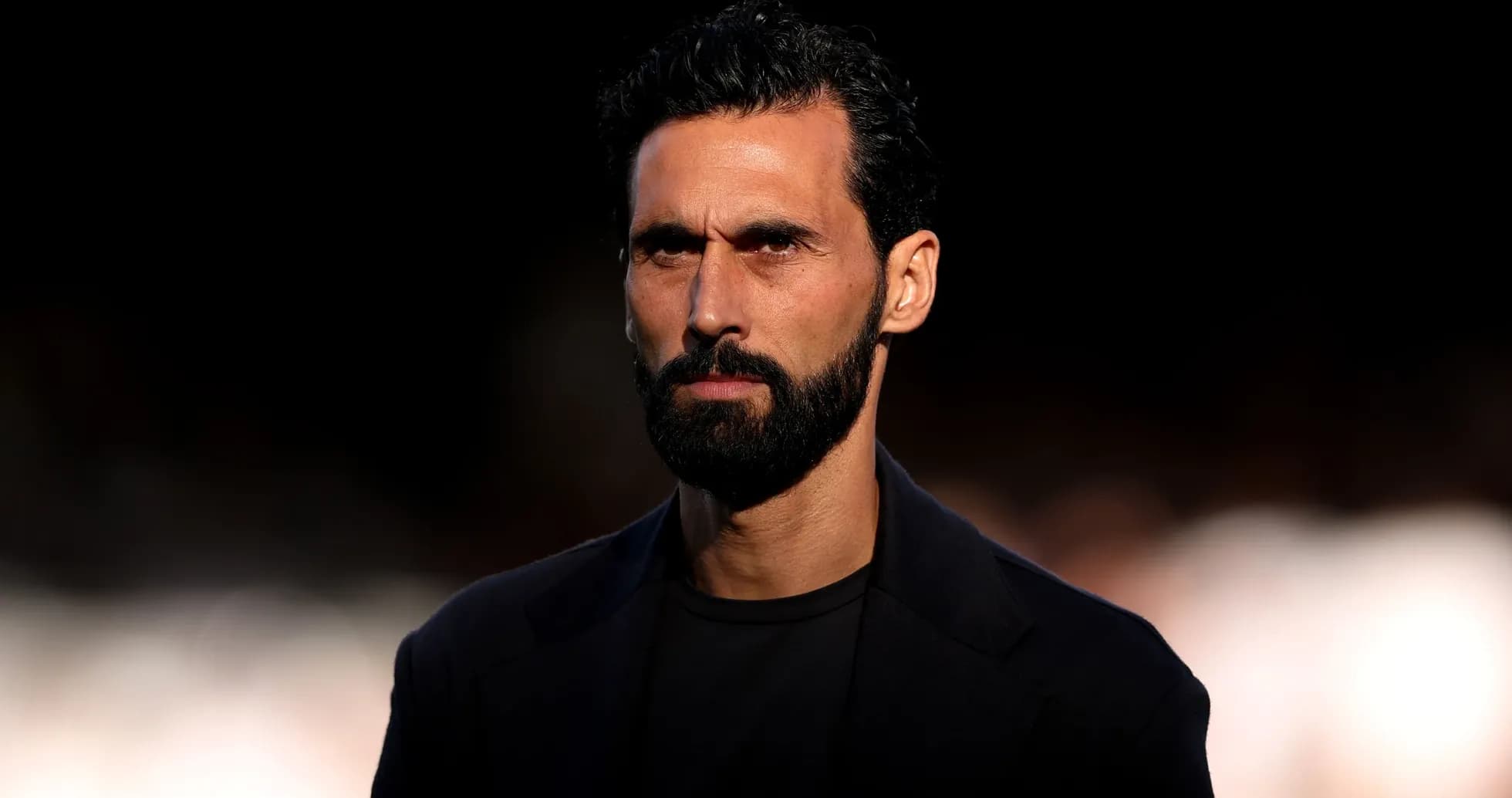 Man with beard and serious expression in dark setting Man with beard and serious expression in dark setting