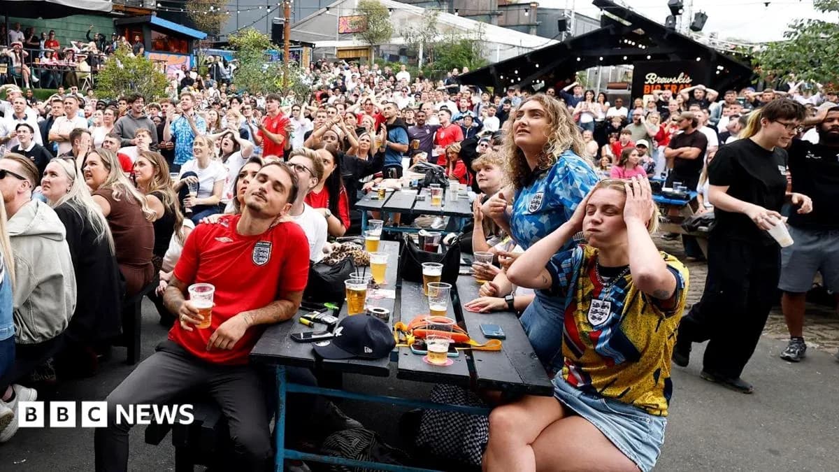 Crowd watching football match at outdoor venue Crowd watching football match at outdoor venue