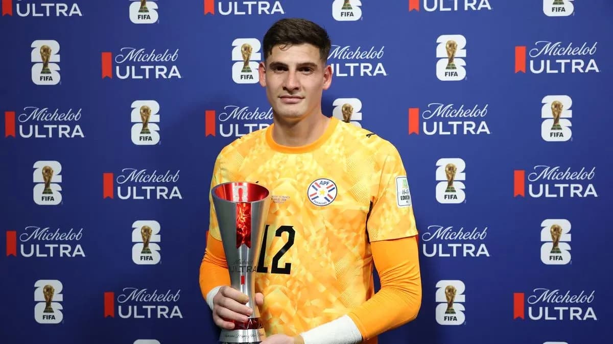 Goalkeeper holding trophy at press event Goalkeeper holding trophy at press event