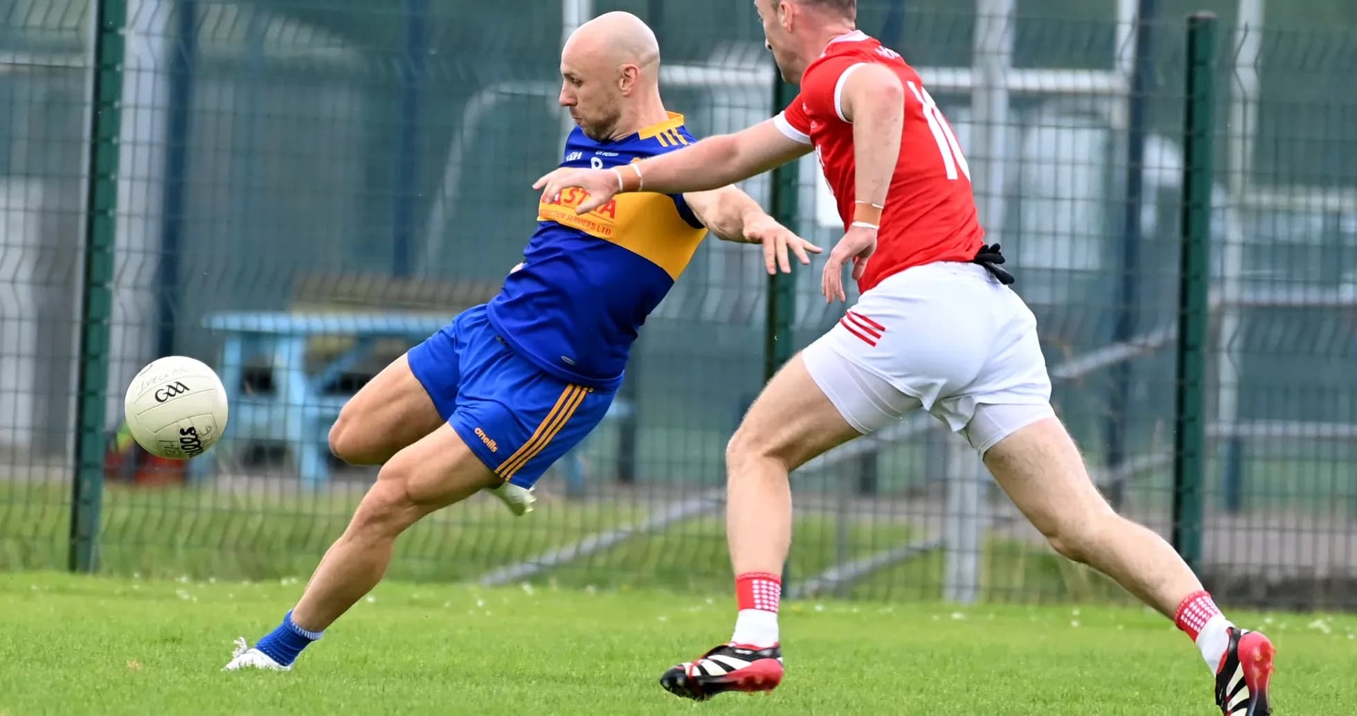 Two players competing for the ball during Gaelic football match Two players competing for the ball during Gaelic football match