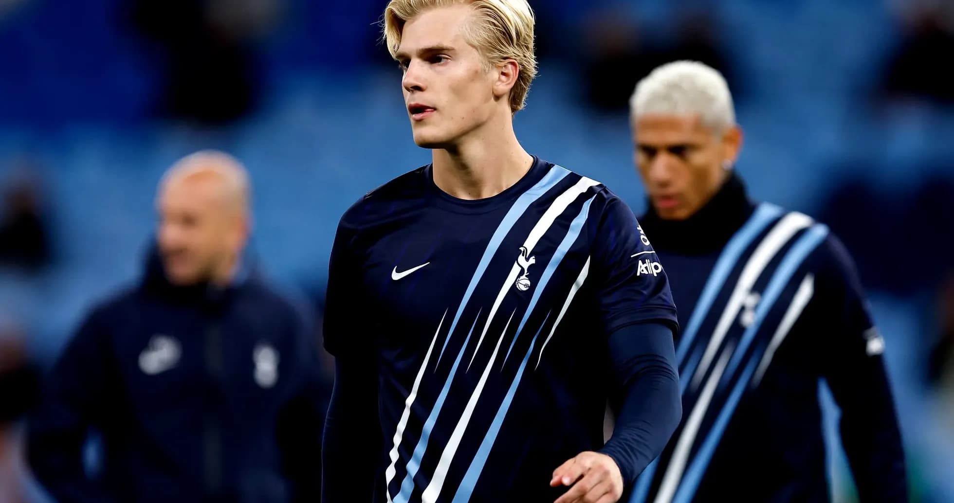 Futbolchi mashg'ulotda, orqa fondda jamoa a'zolari Futbolchi mashg'ulotda, orqa fondda jamoa a'zolari