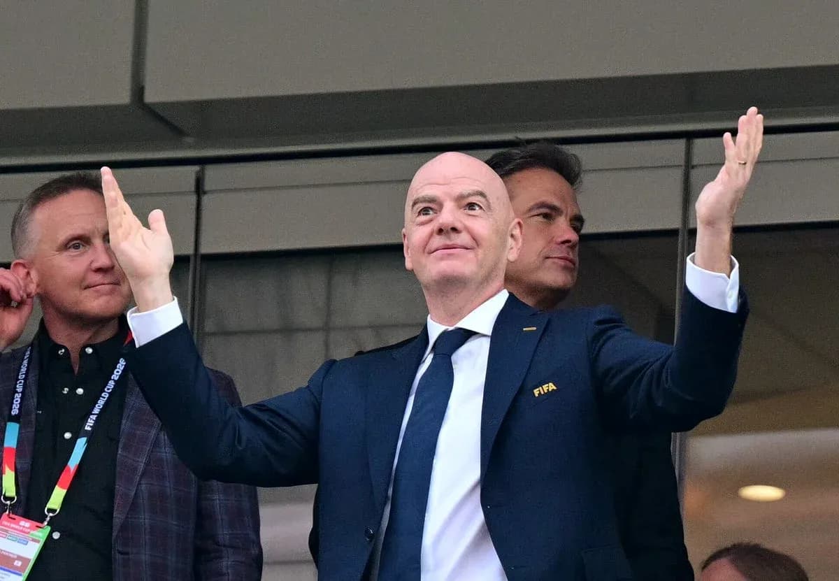 FIFA president gesturing in stadium box during event FIFA president gesturing in stadium box during event