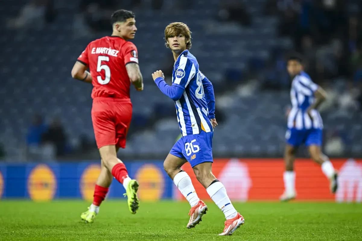 Porto player running during match against opponent Porto player running during match against opponent