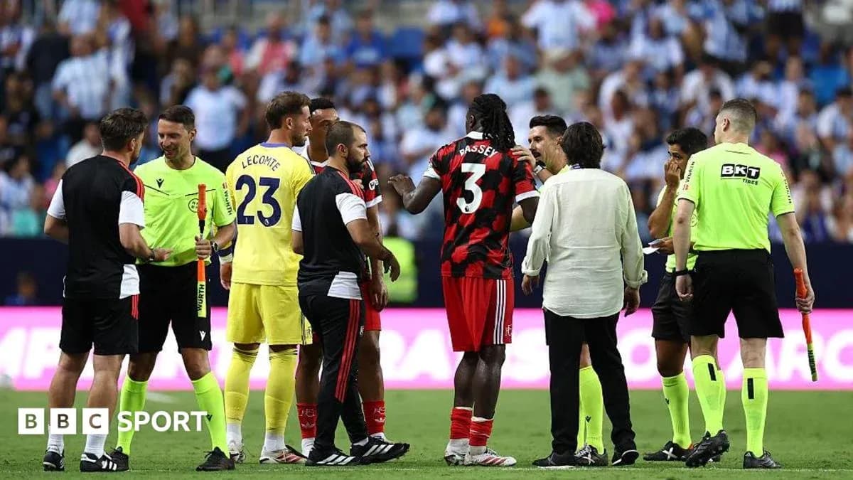 Players and officials discussing on the pitch Players and officials discussing on the pitch