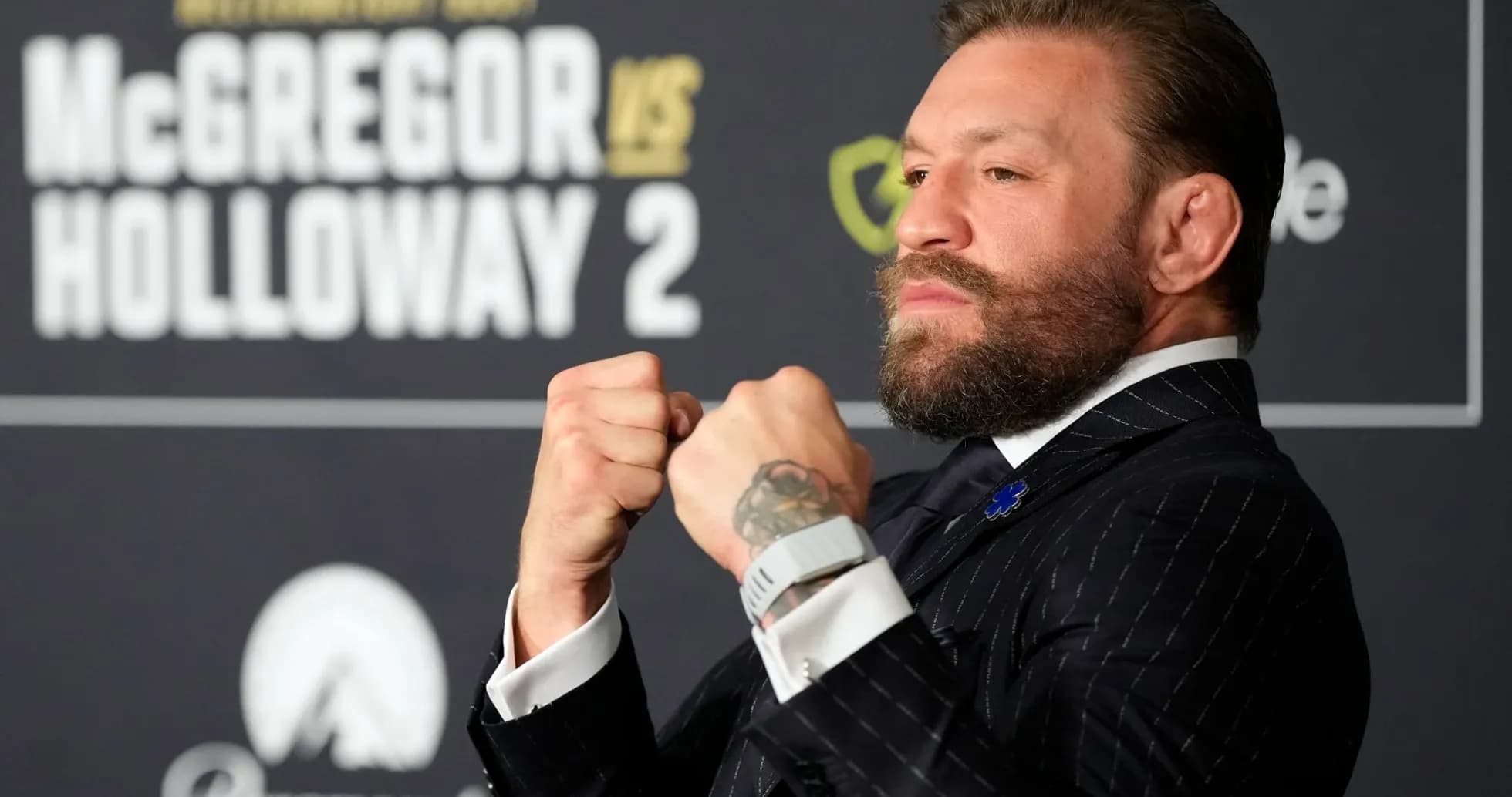 Conor McGregor posing with clenched fists at event Conor McGregor posing with clenched fists at event