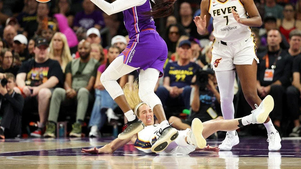 Player on the floor while another jumps over Player on the floor while another jumps over