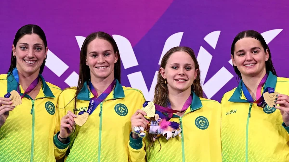 Four swimmers with gold medals on podium Four swimmers with gold medals on podium
