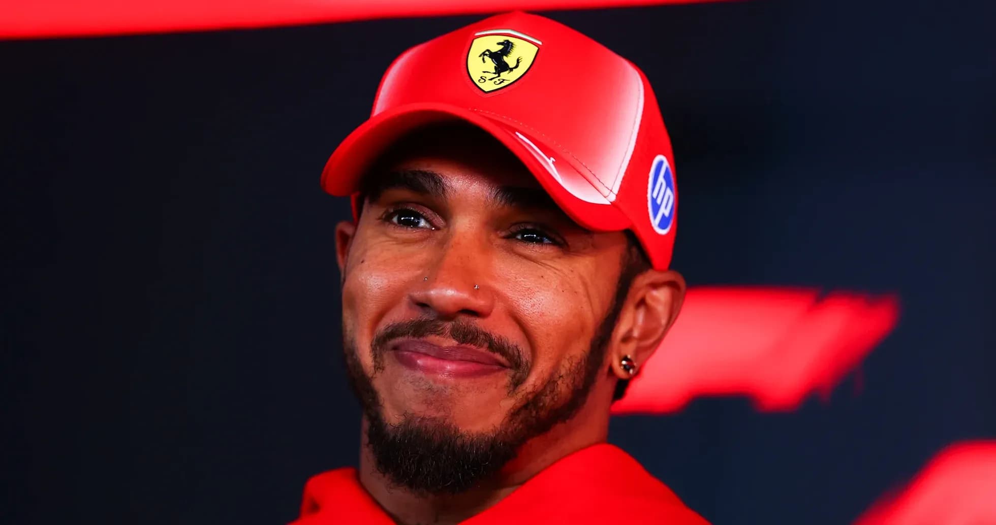 Formula 1 driver wearing Ferrari cap during event Formula 1 driver wearing Ferrari cap during event