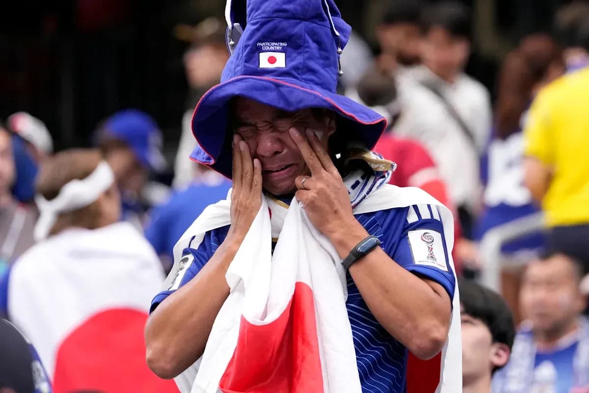 Japan fan wearing national flag and hat in crowd Japan fan wearing national flag and hat in crowd