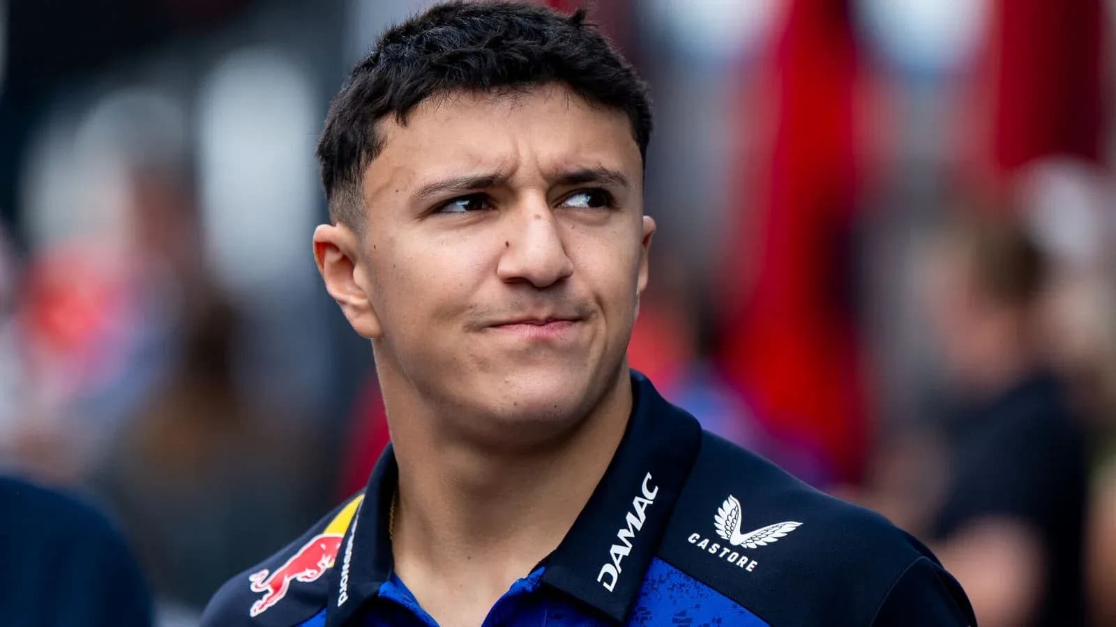 Young driver in team uniform at racing event Young driver in team uniform at racing event