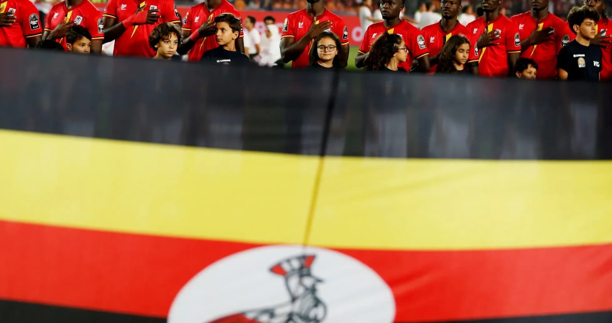 Ugandan players and children with national flag Ugandan players and children with national flag