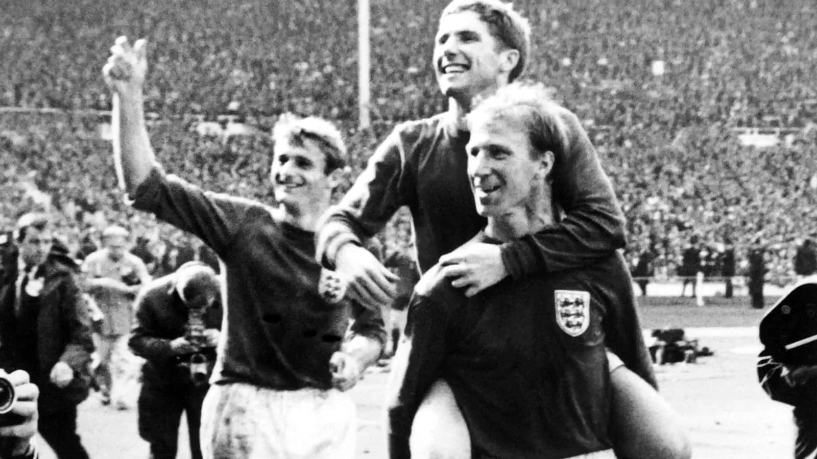 Three football players celebrating on the pitch Three football players celebrating on the pitch