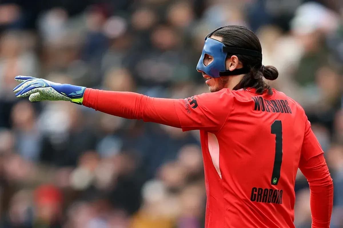 Goalkeeper in red jersey gesturing during match Goalkeeper in red jersey gesturing during match