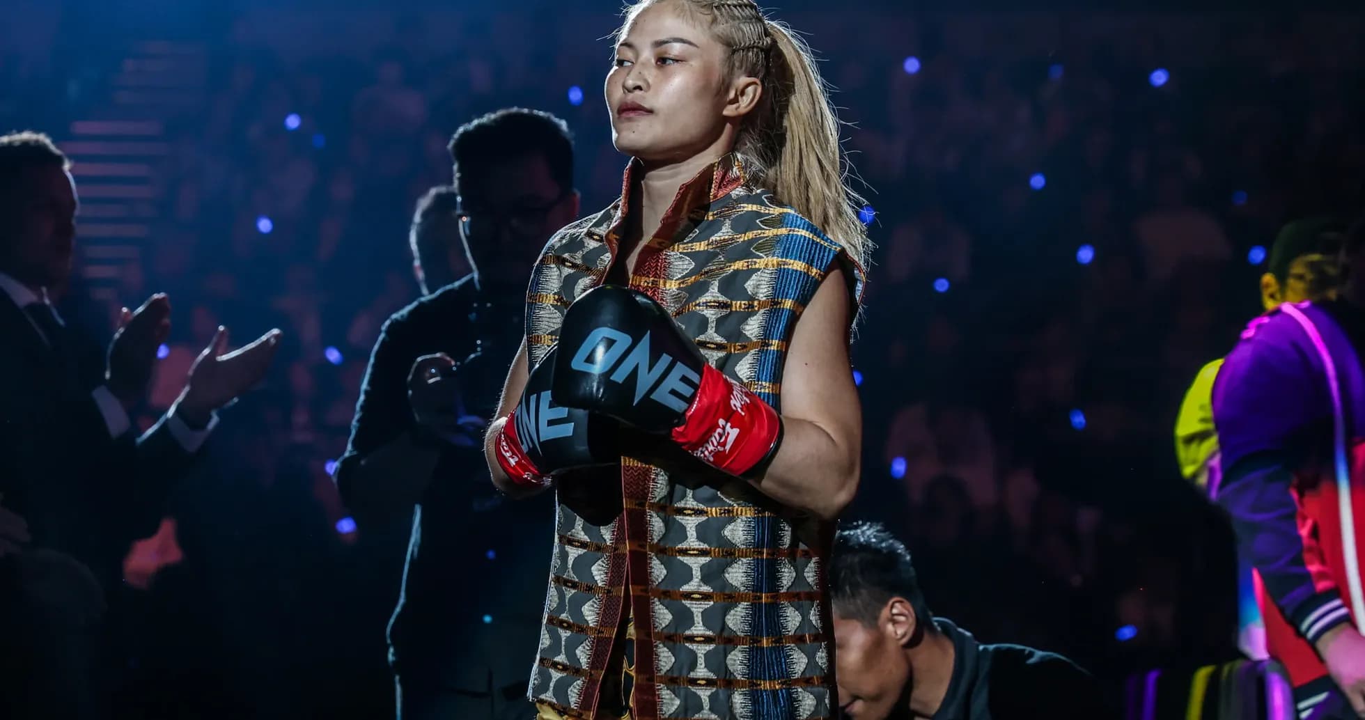 Female fighter entering arena with gloves on Female fighter entering arena with gloves on